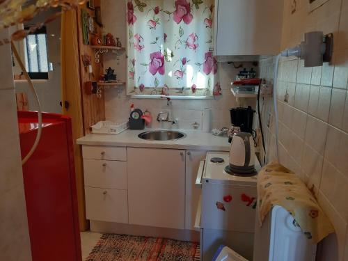 a small kitchen with a sink and a window at Jenny's house,Agiou Ioannou 103 in Artemida