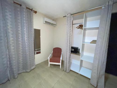 a room with a red chair and a window at Tenexia - La Gaulette Studio in La Gaulette