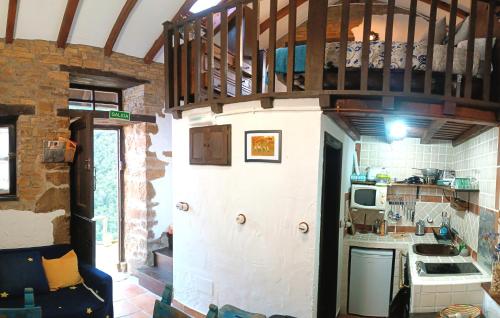 a small kitchen with a balcony on the wall at La Faya - La Vallicuerra Casas Rurales in Mieres