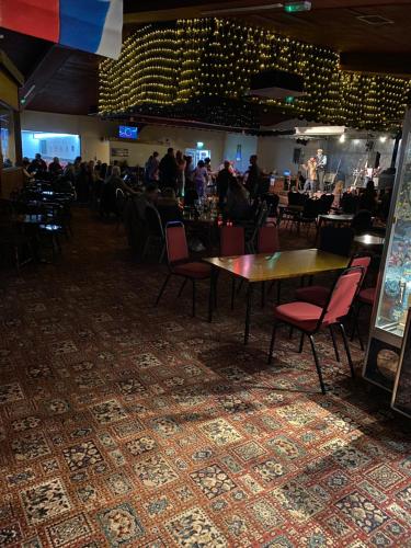 a dining room with tables and chairs and a crowd of people at East Coast Chalets 57 at California Sands, Dog Friendly, FREE Swimming Pool pass in Scratby