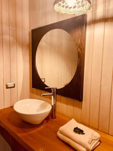 a bathroom with a sink and a mirror on a counter at Bledford Chiloé in Castro