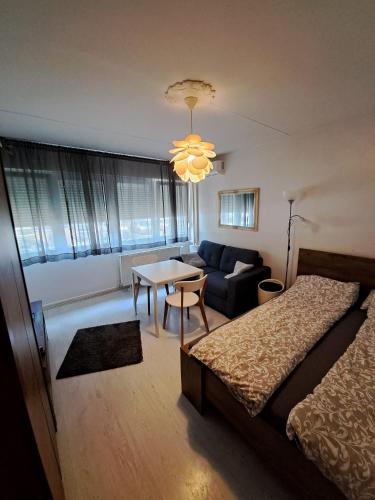 a bedroom with a bed and a couch and a table at Carolina in Zagreb