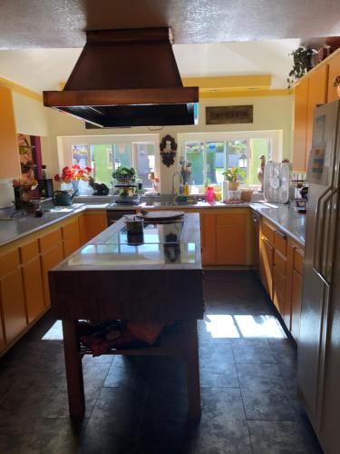 a kitchen with a island in the middle of it at Beautiful Foothill Home in Rancho Cucamonga