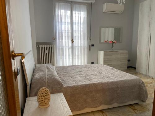 a bedroom with a bed and a dresser and a mirror at SUNNY APARTMENT with big terrace in Rapallo