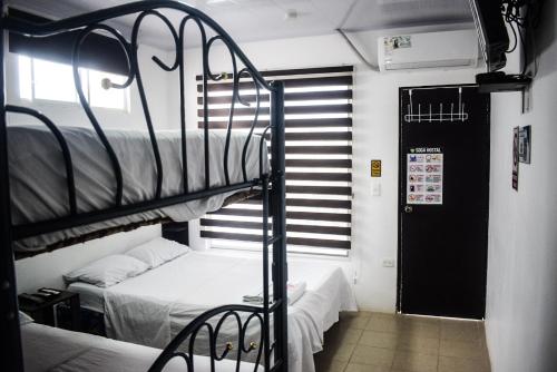 a room with two bunk beds and a door at Soga Hostal in Santa Marianita