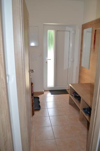 a living room with a tile floor and a kitchen at KVÍTKO in Frymburk