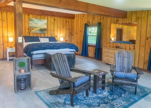 a bedroom with a bed and a desk and chairs at Summer specials on the Saint Lawrence River in Ogdensburg