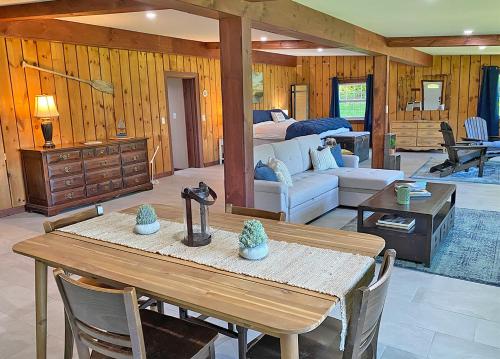 a living room with a table and a bedroom at St Lawrence River Retreat in Ogdensburg