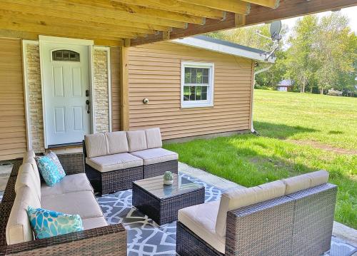 a patio with two couches and a table and a door at St Lawrence River Retreat in Ogdensburg