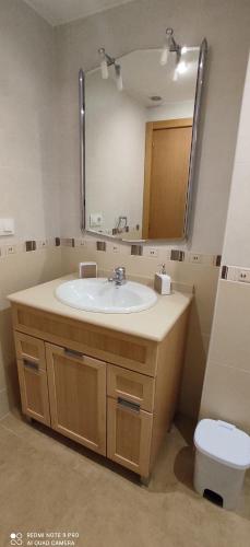 a bathroom with a sink and a mirror and a toilet at TU CASA en Benetússer , VALENCIA in Benetúser
