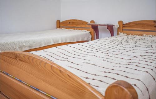two beds sitting next to each other in a room at Pet Friendly Home In Sokole Kuznica With Kitchen in Sokole-Kuźnica