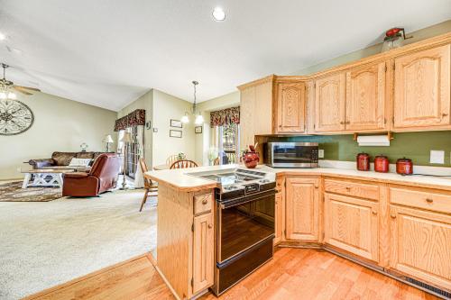 a kitchen with wooden cabinets and a stove top oven at Crooked Canyon Lodge in Rapid City