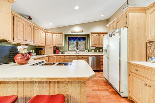 a kitchen with wooden cabinets and a white refrigerator at Crooked Canyon Lodge in Rapid City
