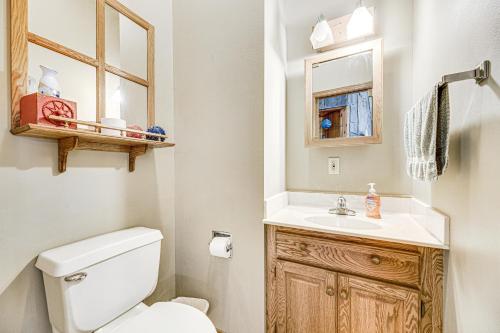 a bathroom with a toilet and a sink and a mirror at Crooked Canyon Lodge in Rapid City
