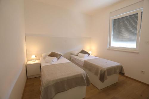 Postel nebo postele na pokoji v ubytování Smil'e Apartments