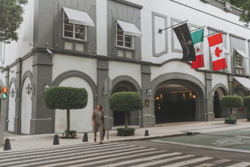 a man standing in front of a building at Four Seasons Hotel Mexico City in Mexico City
