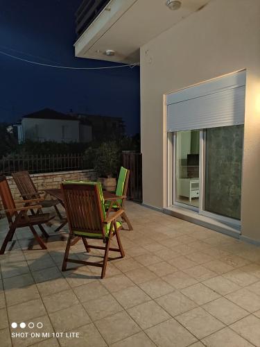a patio with chairs and a table and a window at Diacopto Country Houses in Diakopto