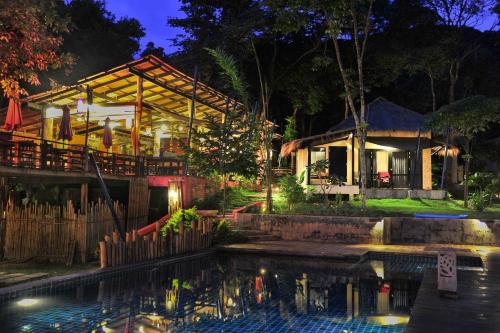 a house with a swimming pool in front of it at LaLaanta Hideaway Resort in Ko Lanta