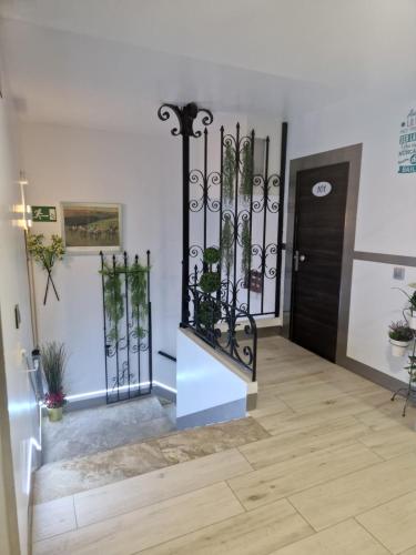 a hallway with a black gate and a door at Hostal Boutique Luna de Gavín in Cullera