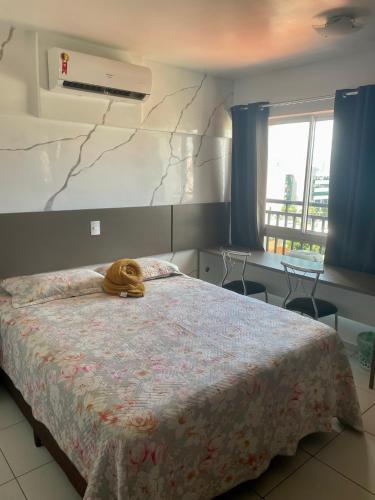 a bedroom with a bed with a stuffed animal on it at Smart Residence flat 505 in Teresina
