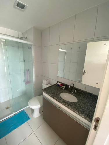 a bathroom with a sink and a toilet and a mirror at Smart Residence flat 505 in Teresina