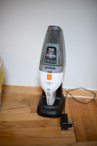 a hair dryer sitting on top of a wooden floor at Apartman Yellow House in Sarajevo