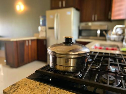 a pot sitting on top of a stove in a kitchen at PARADISe VILLA 2 in Mammee Bay
