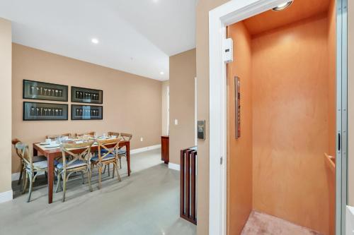 a dining room with a table and chairs at Luxury Villa Less Than A Mile From Disneyworld -Bonus Elevator- in Orlando