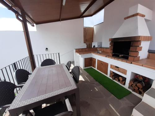a dining room with a table and a fireplace at Vv Puerto del Trigo - Stella in Alojera