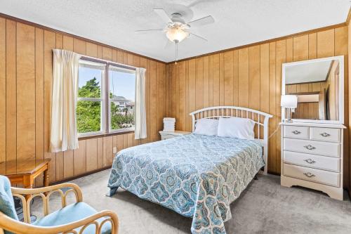 a bedroom with a bed and a window at Sunflower in Holden Beach