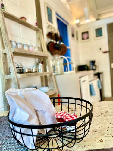 a black basket with two red balls on a table at La Bocana Beach House in Santa Cruz Huatulco