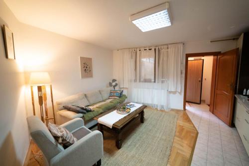 a living room with a couch and a table at Apartman Yellow House in Sarajevo