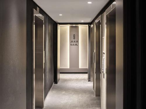 a hallway with a row of elevators in a building at Radisson Blu Hotel, Hasselt in Hasselt