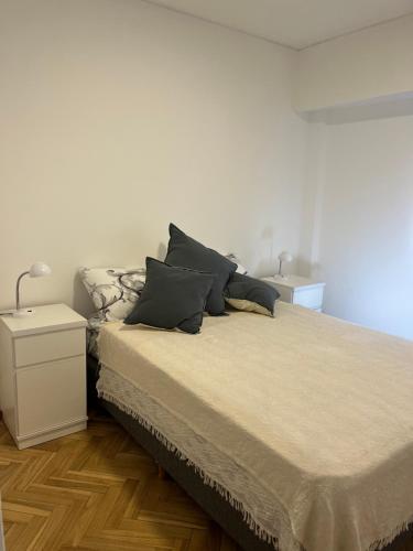 a bedroom with a bed with two pillows on it at Departamento luminoso en Rosario centro in Rosario