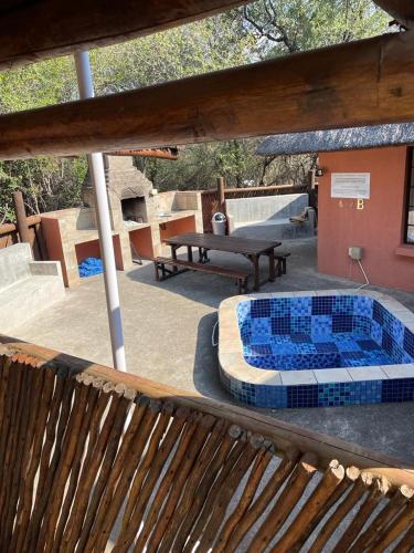 a patio with a table with blue tiles on it at John and Noleen's place in Marloth Park