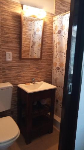 a bathroom with a sink and a toilet at Coralca in Martínez