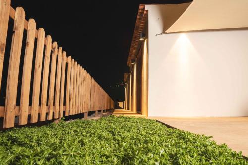 a green bush next to a wooden fence at BASÂLTO Casas Rurales in Hermigua