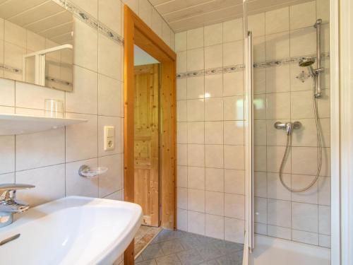 a bathroom with a shower and a sink and a toilet at Chalet Blaserhof in Zell am Ziller