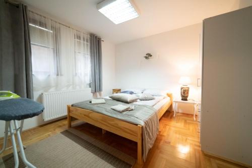 a bedroom with two beds and a window at Apartman Yellow House in Sarajevo