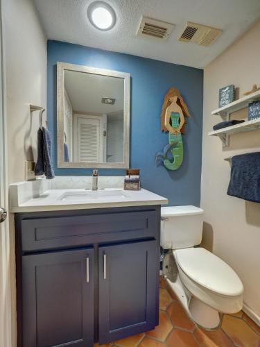 a bathroom with a toilet and a sink and a mirror at Costa Crinks at Aransas Princess in Port Aransas