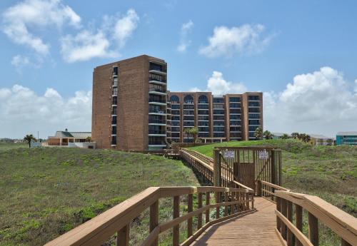 a wooden boardwalk leading to a building on a hill at Costa Crinks at Aransas Princess in Port Aransas