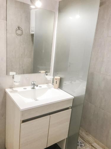 a bathroom with a white sink and a mirror at Cabañas Titina's Lake in Potrero de Garay