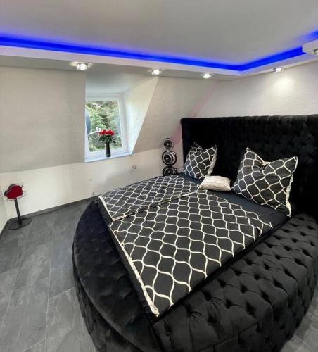 - une chambre dotée d'un grand lit avec un cadre noir dans l'établissement Phöenixpalace Whirlpool & Infarotsauna, à Dortmund