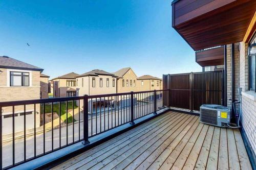 a deck with a fence and some houses at NEWLY BUILT LUXURIOUS 3BRM TOWN HS/AIRPORT/PARKING in Brampton