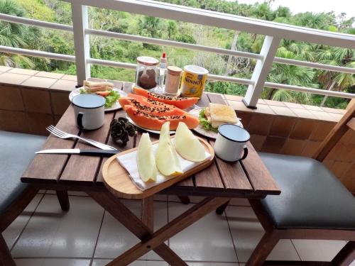 a wooden table with a plate of food on it at Gran Lençóis Flat Barreirinhas APT 510 in Barreirinhas