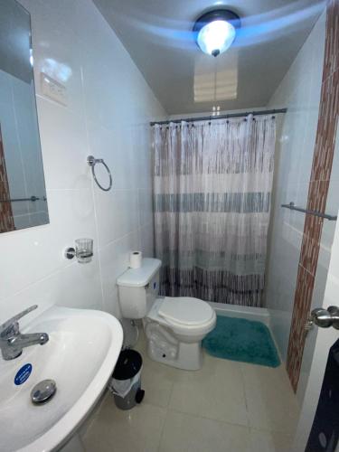 a bathroom with a toilet and a sink and a shower at comfortable 3 bedroom condo with free parking spot building 5 in Los Paredones