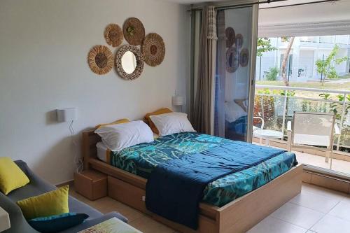 a bedroom with a bed and a large window at U Are We R St Martin Studio Cosy Marigot, Wi-Fi ,Piscine in Marigot