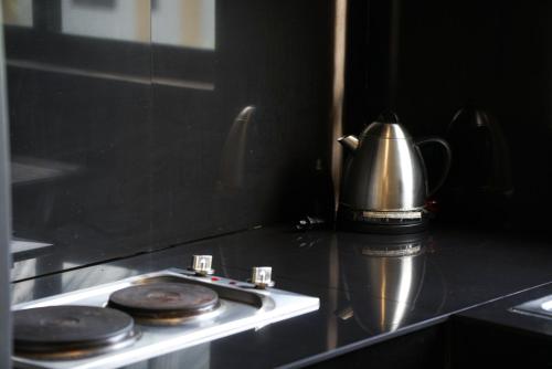 a tea kettle sitting on top of a stove at Garden Vista Hotel in Davao City
