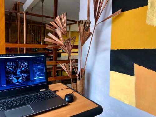 a laptop computer sitting on a desk with a mouse at Refugio del Jaguar in Medellín