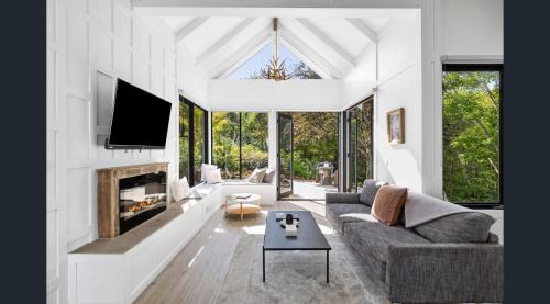 a living room with a couch and a fireplace at Daylesford Lake Garden Villas in Daylesford